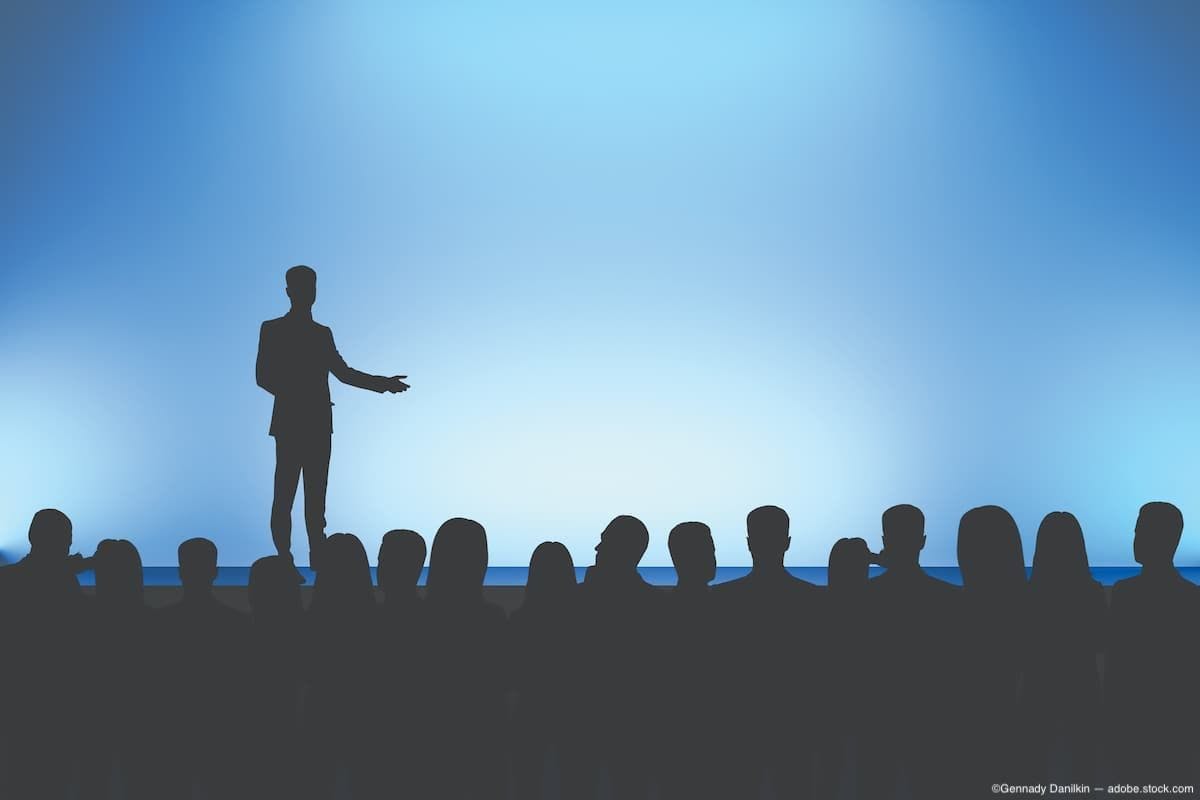 Silhouette of speaker and audience Image Credit: AdobeStock/GennadyDanilkin