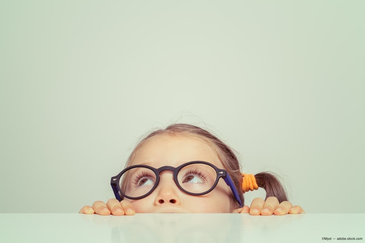 Child with glasses peering over table Image Credit: AdobeStock/Myst