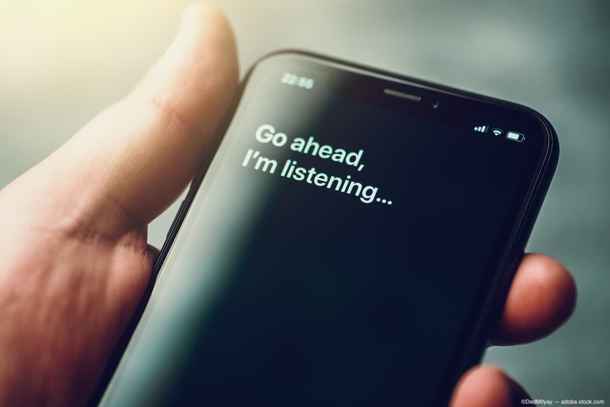 Virtual assistant app on phone, text: "Go ahead, I'm listening..." Image Credit: ©DedMityay - adobe.stock.com