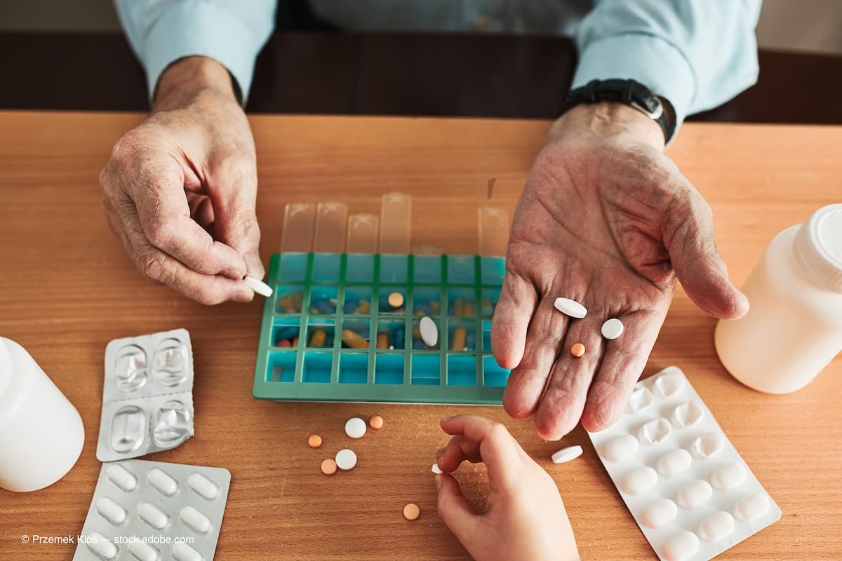 Senior man organizing his medication into pill dispenser. Senior man taking pills from box. Healthcare and old age concept with medicines. Medicaments on table. (Adobe Stock / Przemek Klos)
