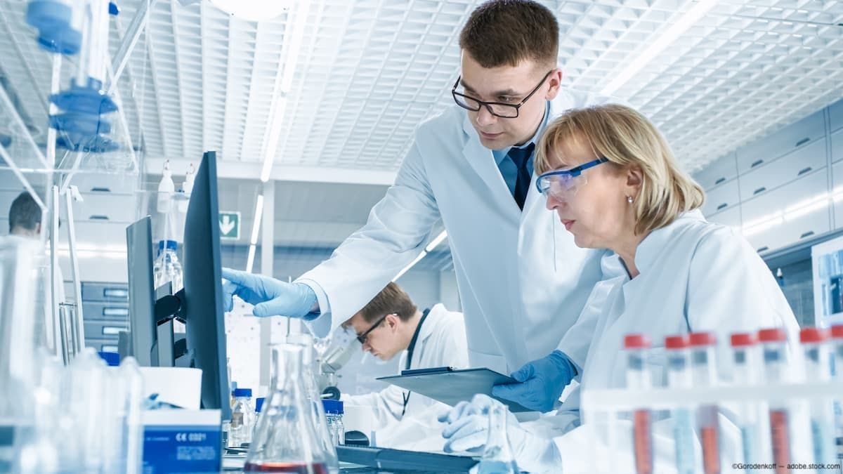 Researchers look over test results on computer Image Credit: AdobeStock/Gorodenkoff