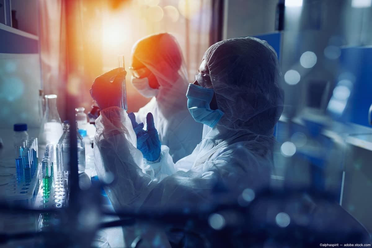 Scientist looking at vial in clinical trial Image Credit: AdobeStock/alphaspirit