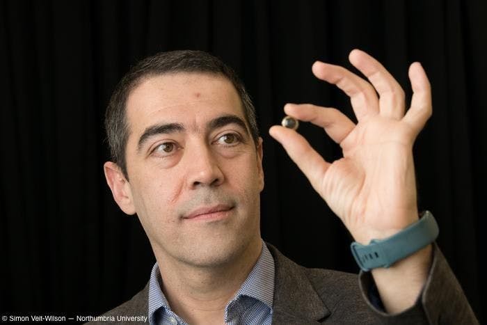 Hamdi Torun, PhD, holding a contact lens between his left thumb and index finger Image Credit: Simon Veit-Wilson - Northumbria University