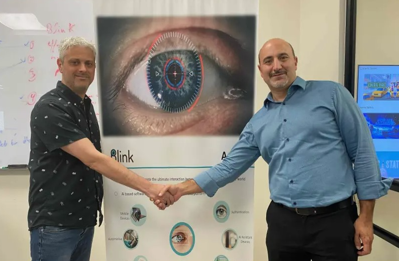 Blink CEO Oren Yogev (left) shakes hands with Yagen Moshe (right), CEO and president of Shamir Optical.