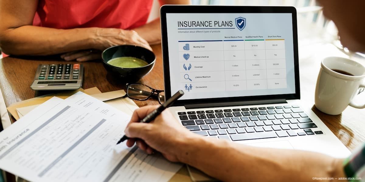 Two people at table reviewing insurance paperwork Image Credit: AdobeStock/Rawpixel.com