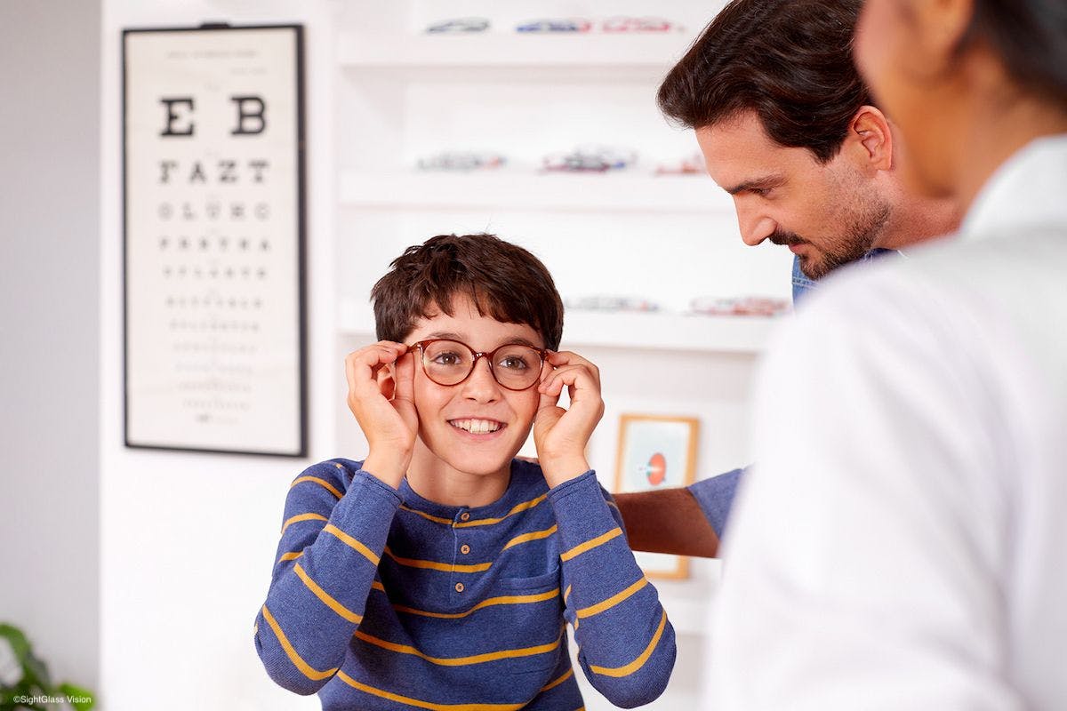 Boy tries on glasses for myopia control Image credit: SightGlass Vision