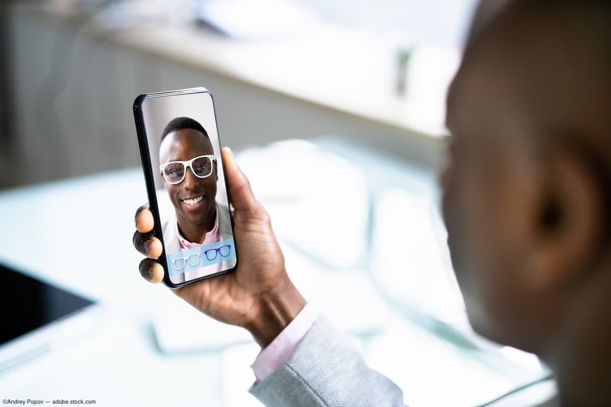 Man choosing frames on phone through virtual try-on Image Credit: AdobeStock/AndreyPopov