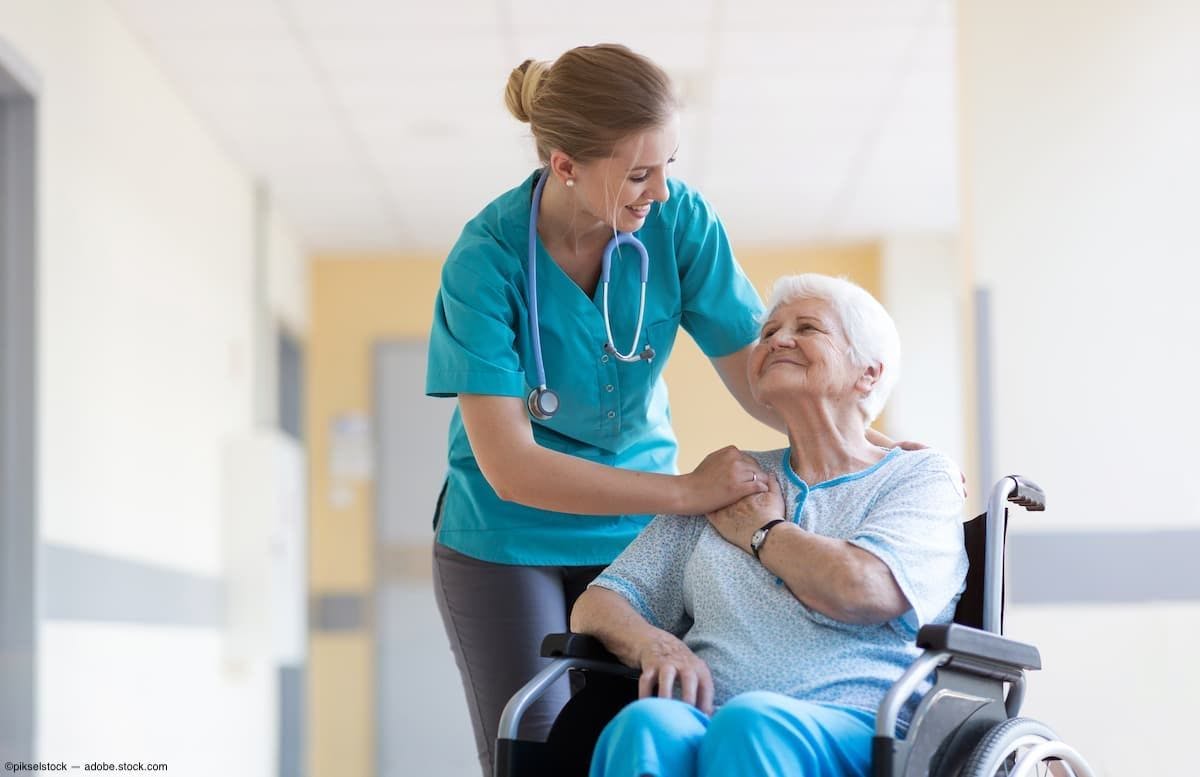 Nurse comforts older patient in wheelchair in hospital Image Credit: AdobeStock/pikselstock