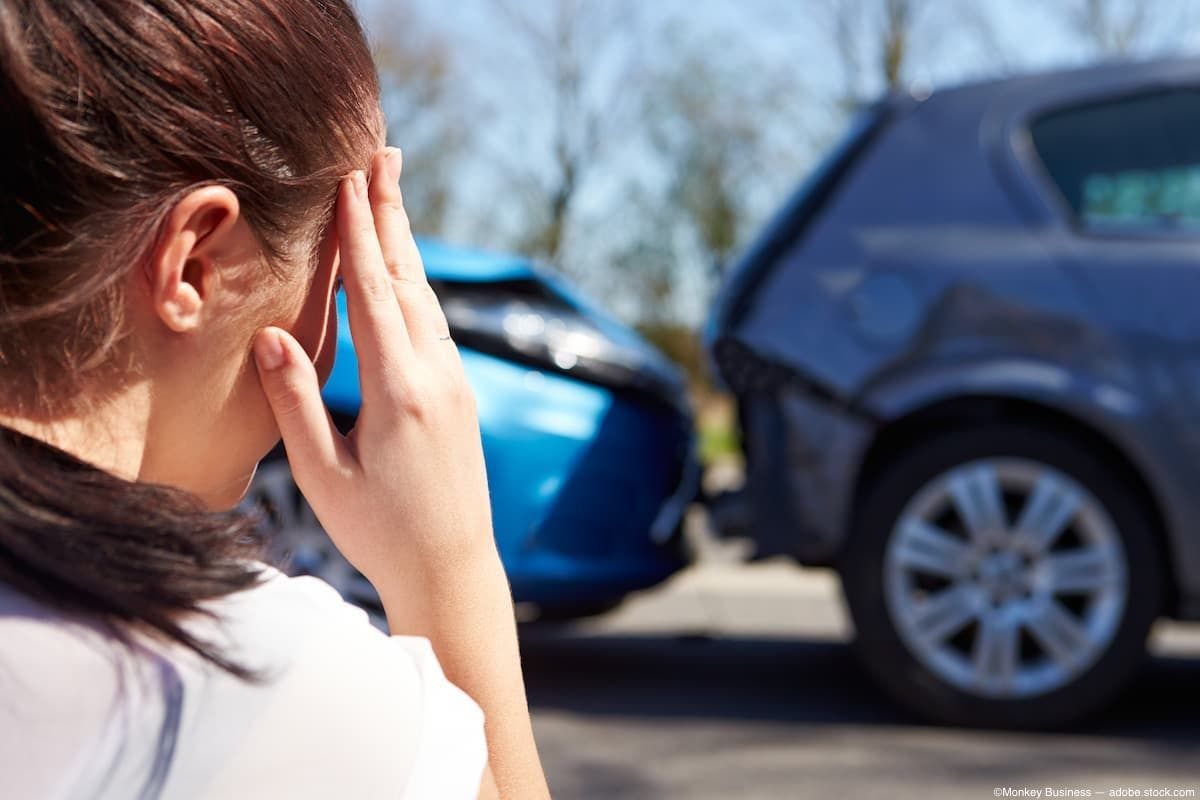 Woman onlooking car crash Image Credit: AdobeStock/MonkeyBusiness