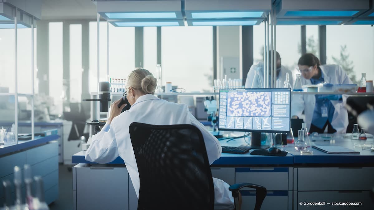 Medical Laboratory with Team of Scientists Working. Microbiologist Looking under Microscope and working on Computer. Developing Drugs, Gene Editing, High-Tech Biotechnology Research. Back View Shot (Adobe Stock / Gorodenkoff)