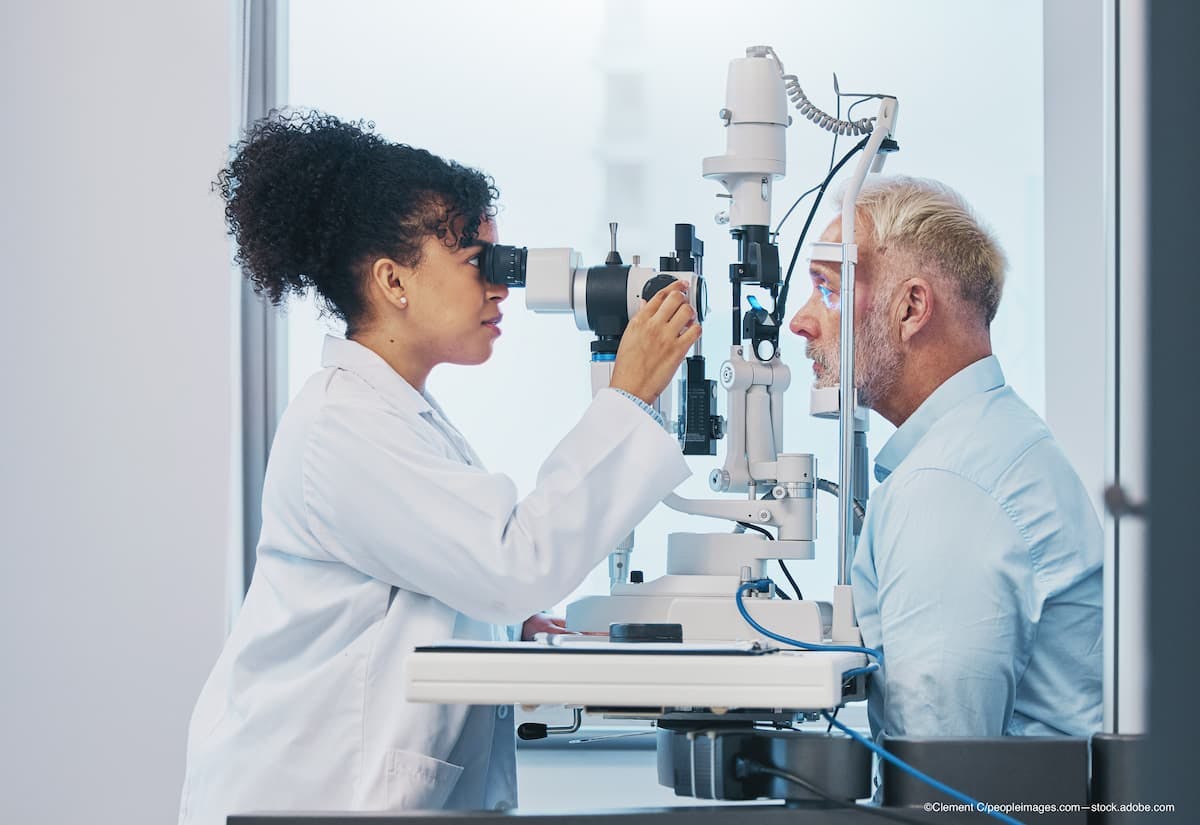 optometrist examines man with ptsosis in eye exam. Image credit: Adobe Stock / Clement C_peopleimages.com.jpg