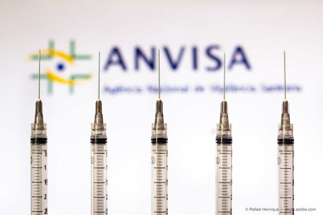 March 30, 2021, Brazil. In this photo medical syringes is seen with National Health Surveillance Agency (Anvisa) logo displayed in the background. (Adobe Stock / Rafael Henrique)