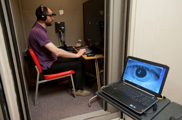 Research engineer Sylvain Favrot wears the portable eye-tracker component of the visually guided hearing aid (VGHA) developed by Gerald Kidd, PhD, and other researchers. Photo by Cydney Scott, courtesy of Boston University.