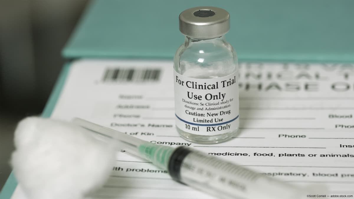 Needle and paperwork on table for clinical trial Image Credit: AdobeStock/ScottCornell