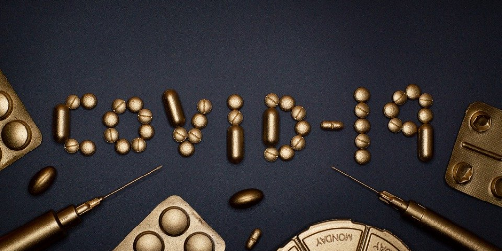 pills spell out "COVID-19"