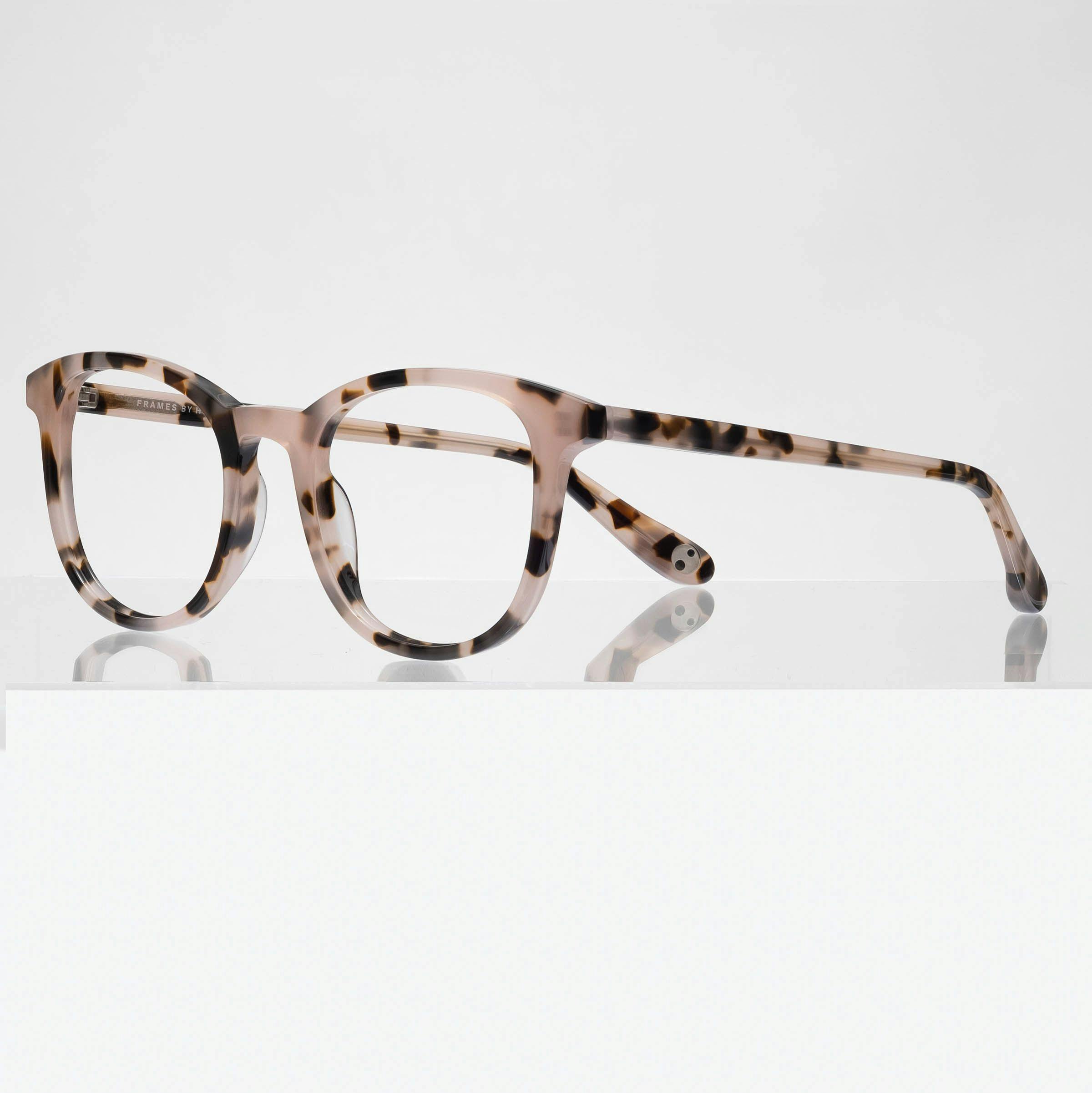 Astrid is a medium, feminine, acetate frame that includes prescription lenses. It is available in blush tortoise, black tortoise and champagne crystal color options.
