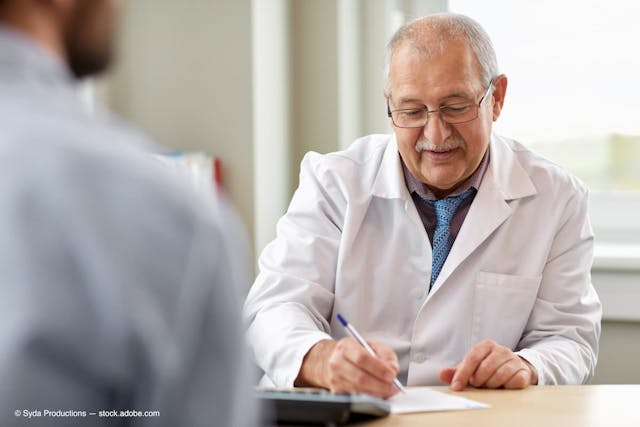 doctor writing prescription for patient at clinic. (Adobe Stock / Syda Productions)