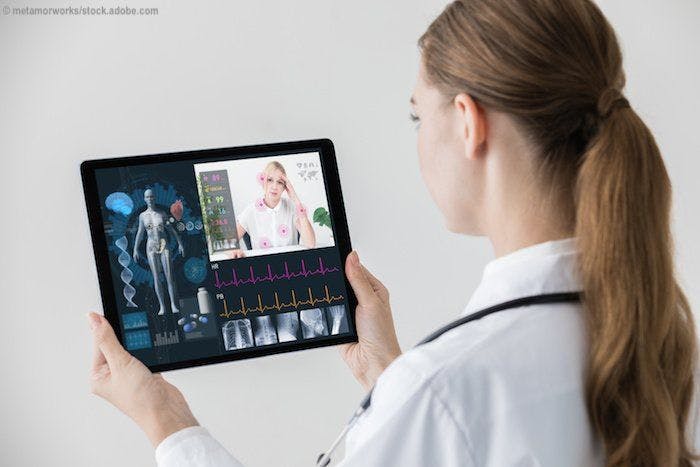 Doctor holding a tablet looking at medical images