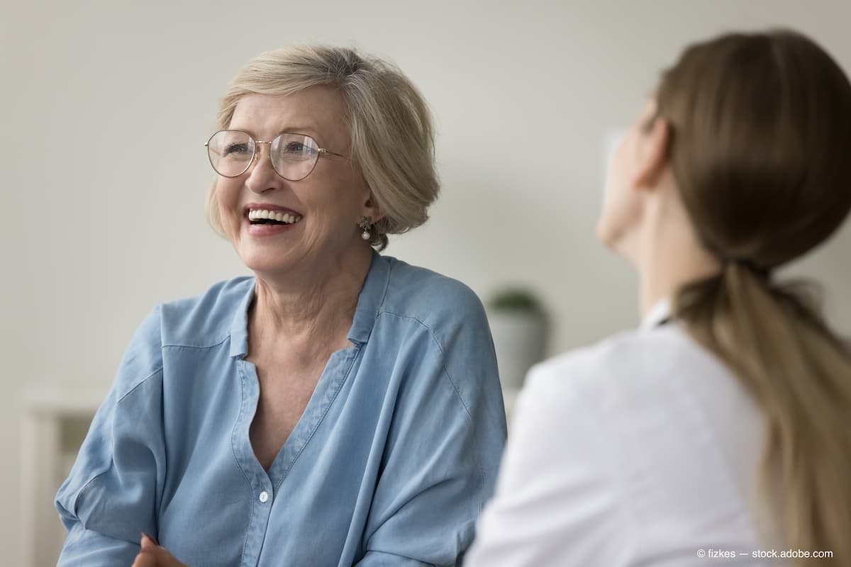 Mature woman clinic patient laughs during visit in clinic, get professional medicare, receive consultation looks optimistic feels happy. Eldercare, medicine, professional medical services, insurance (Adobe Stock / fizkes)